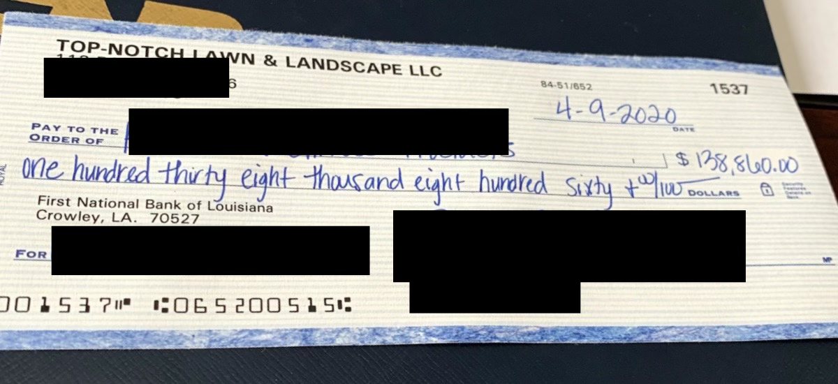 The first big check from Cory's lawn company, for $138,860, dated 2020