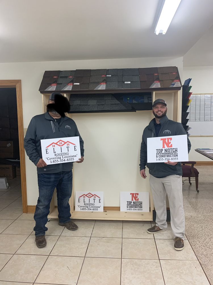 Cory with his Elite Roofing and Top Notch Construction signs