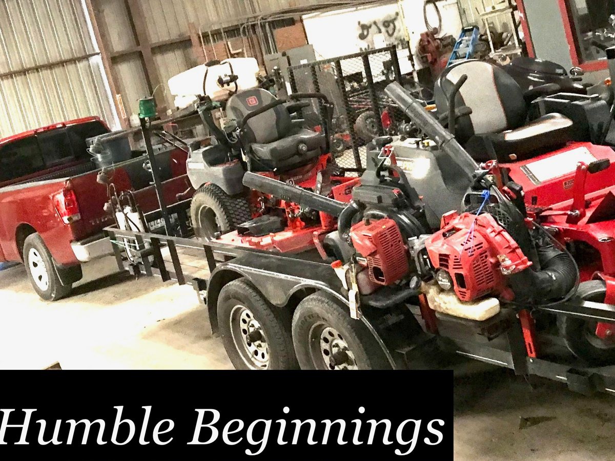 Cory's first lawn trailer loaded with mowers and equipment